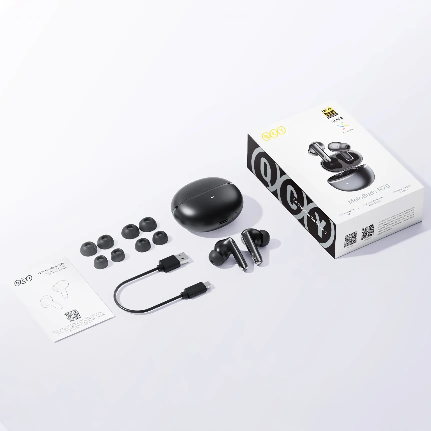 QCY MeloBuds N70 HT18 box contents with charging case, ear tips, and Type-C cable